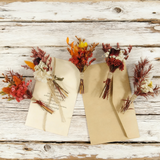 Autumn-toned dried mini bouquets with rust and amber blooms, hand-tied with twine