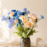 Blue, peach and white faux poppies with ruffled petals and grey-green foliage