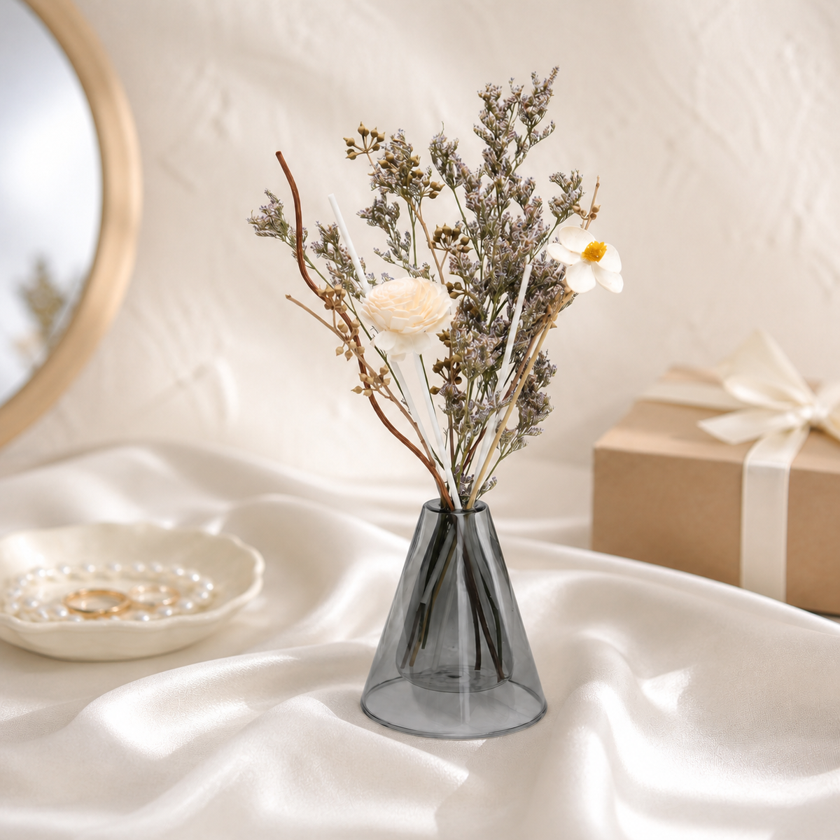 Lavender dried statice with white blooms in a grey glass vase