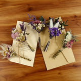 Five dried mini bouquets in violet and cream, tied with twine on kraft envelopes