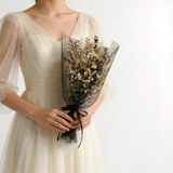 Dried bridal bouquet of baby's breath and eucalyptus in black tulle with a satin ribbon