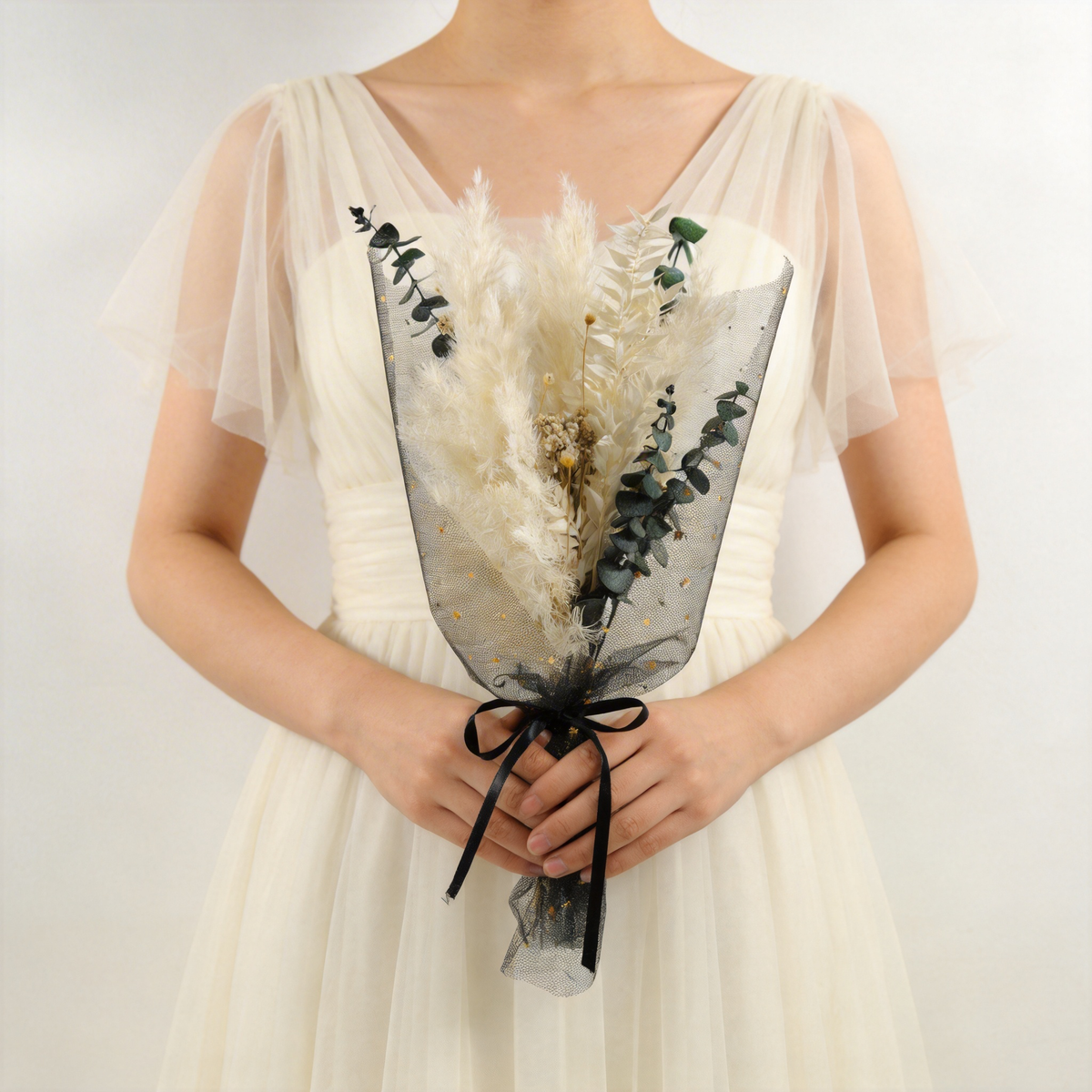 Ivory pampas and eucalyptus dried bridal bouquet wrapped in black tulle